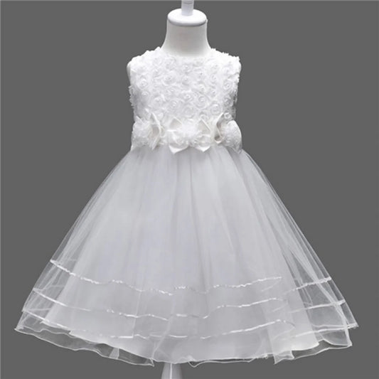 White flower girl dress on a mannequin against a dark gray background