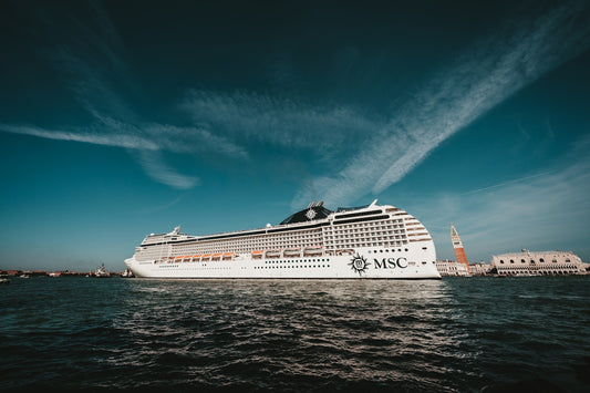 white MSC cruise ship under a blue sky