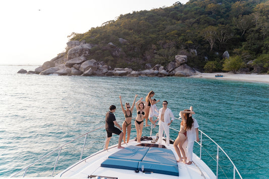 a group of people standing on the back of a boat