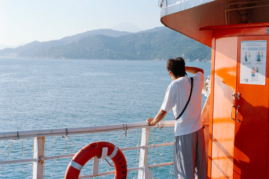Man on boat looking at distant mountains