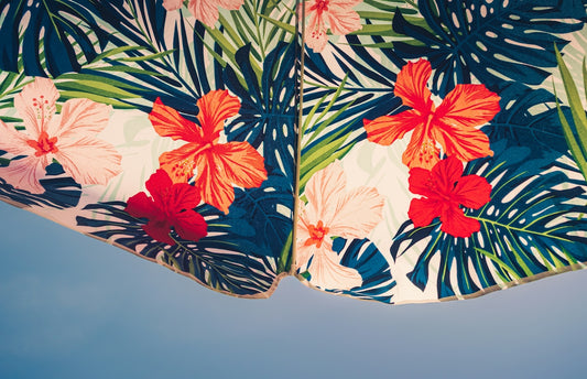 Vibrant tropical fabric with hibiscus flowers on blue
