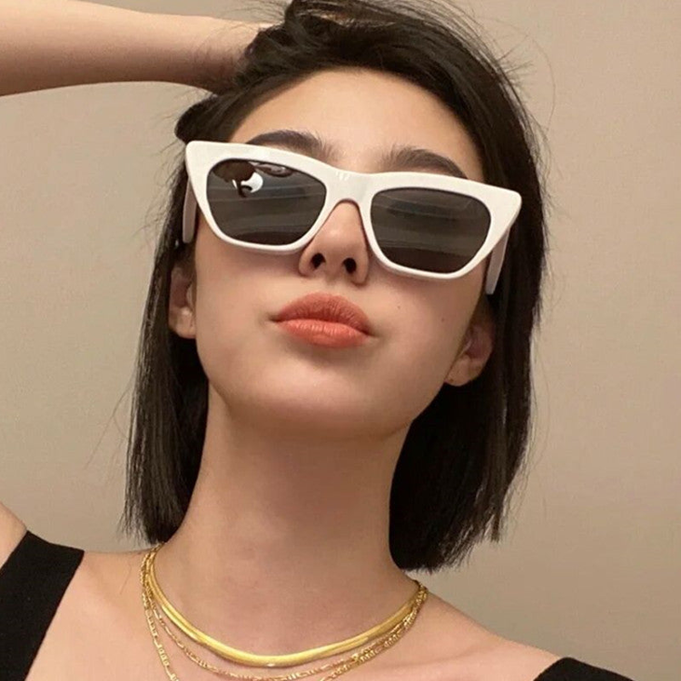 Teen girl in white sunglasses posing confidently — trendy vacation-ready accessories for teens.