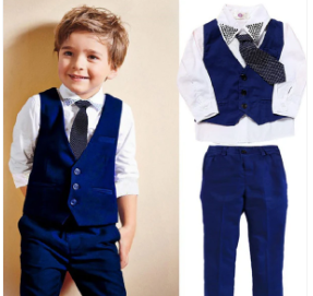 Little boy in a blue vest suit with matching shirt and tie – kids’ sets for cruise clothing, vacation wear, and family travel.