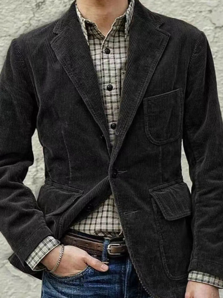 Men’s evening outfit—dark corduroy blazer over a plaid shirt with jeans—refined casual cruise look.