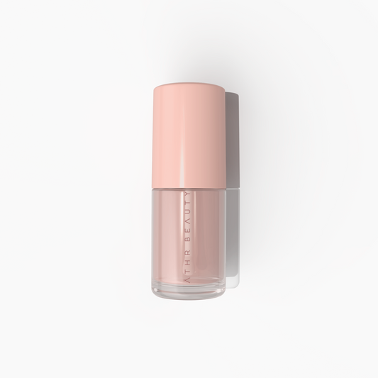 Pink bottle of skincare product with 'Athe Beauty' branding on a white background