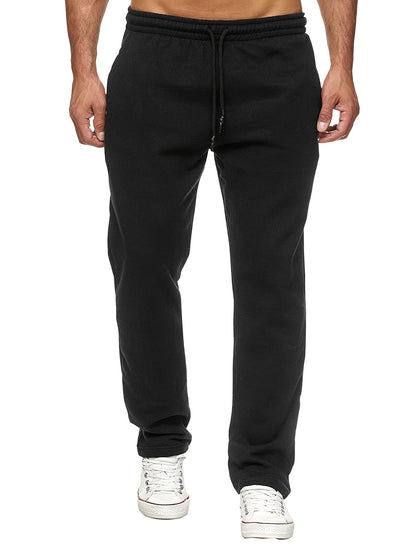 Black sweatpants worn by a person on a white background