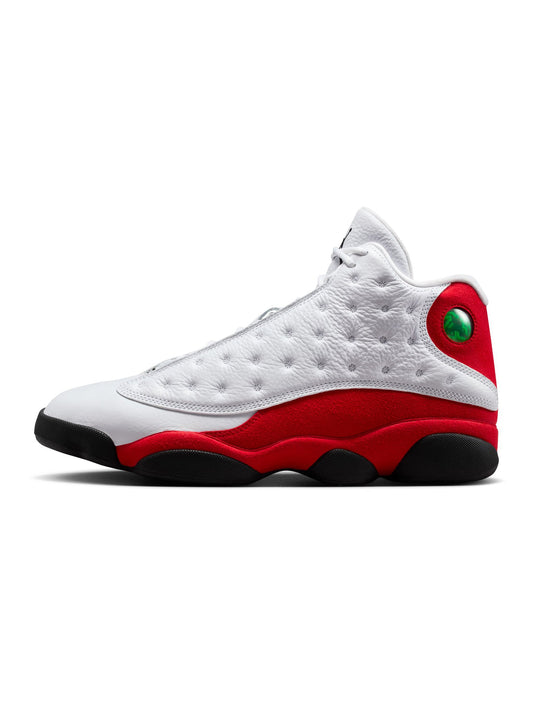 White and red sneaker with a green accent on a white background
