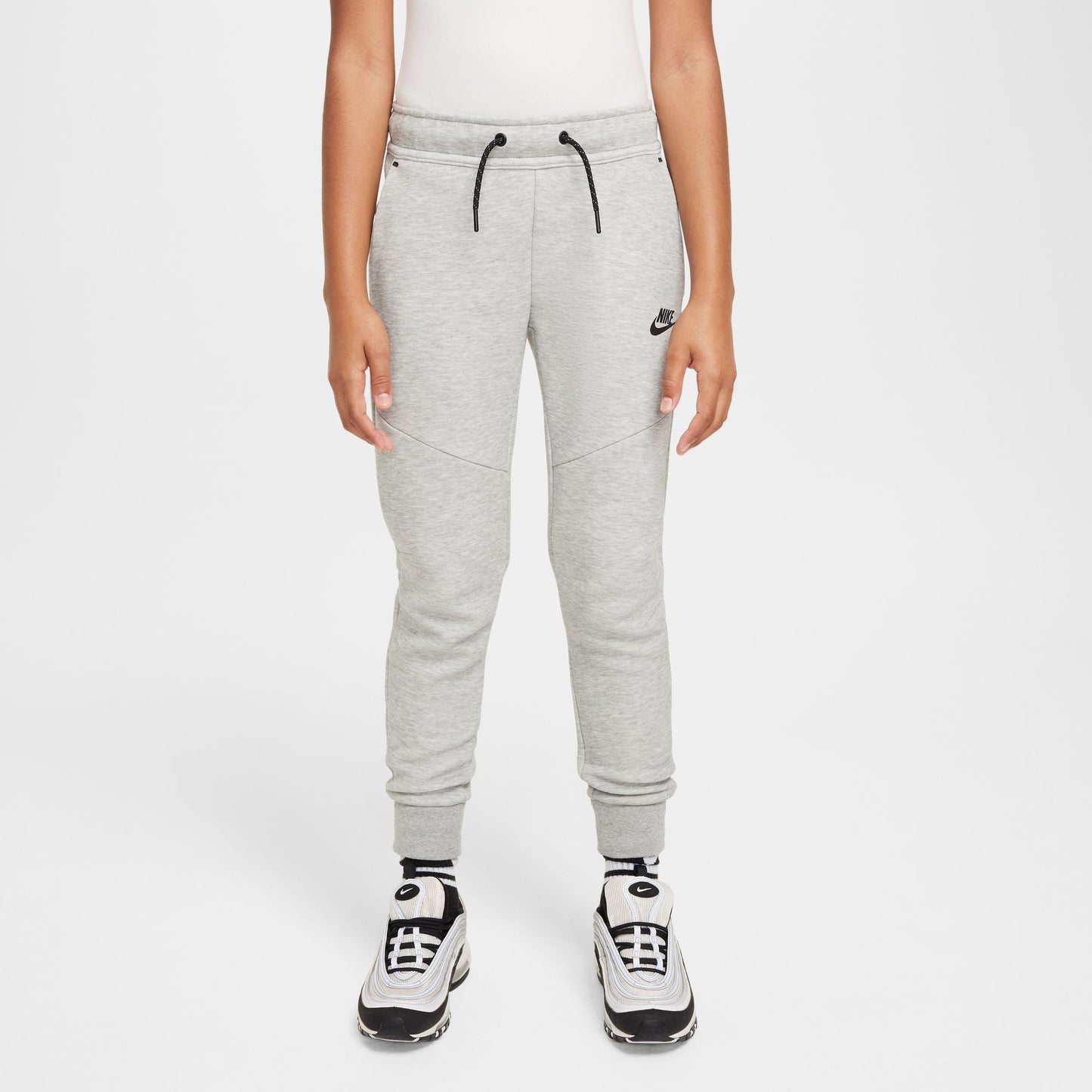 Person wearing gray Nike sweatpants on a white background