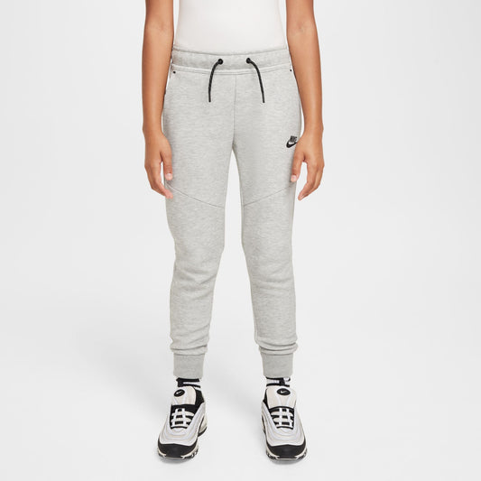 Person wearing gray Nike sweatpants on a white background