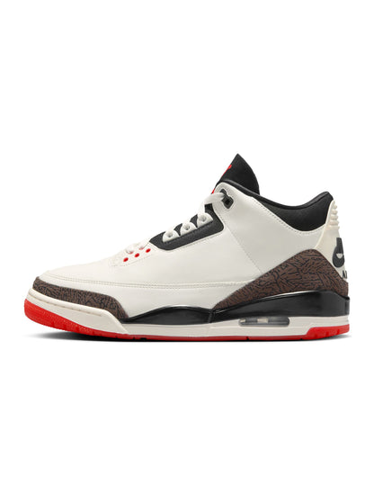 White sneaker with black and red accents on a white background
