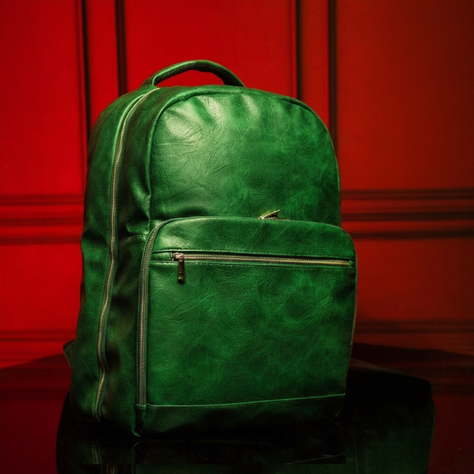Green leather backpack on a reflective surface with a red background