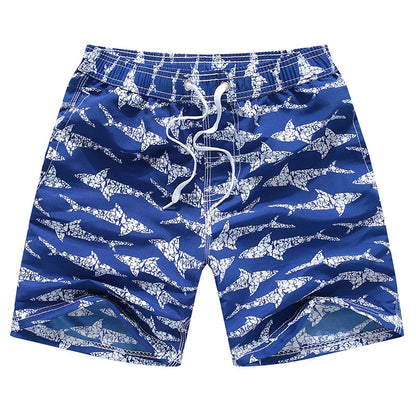 Blue swim shorts with white shark pattern on a white background