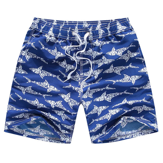 Blue swim shorts with white shark pattern on a white background