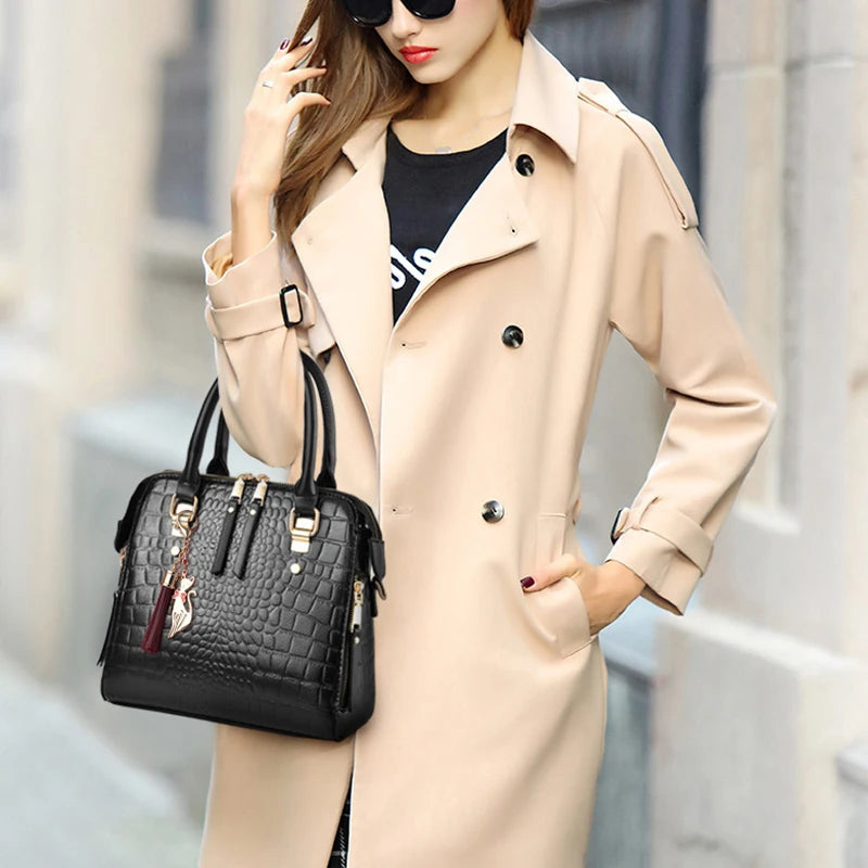 Woman in a beige trench coat holding a black handbag with a blurred background