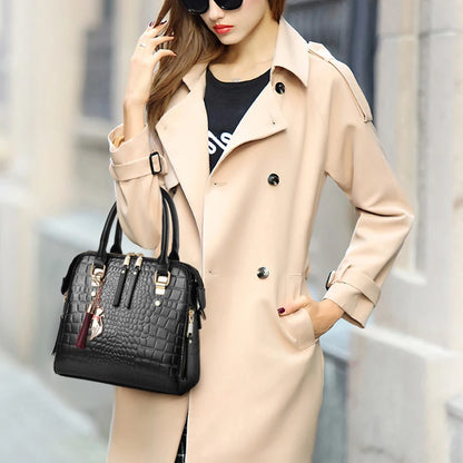 Woman in a beige trench coat holding a black handbag with a blurred background