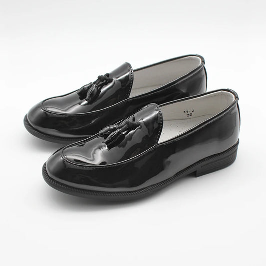 Pair of black patent leather loafers on a white background