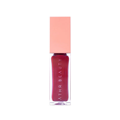Lipstick with pink cap and visible brand name on a white background