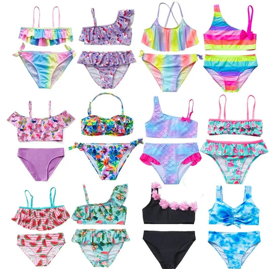 Collection of colorful children's swimsuits in various patterns and designs.