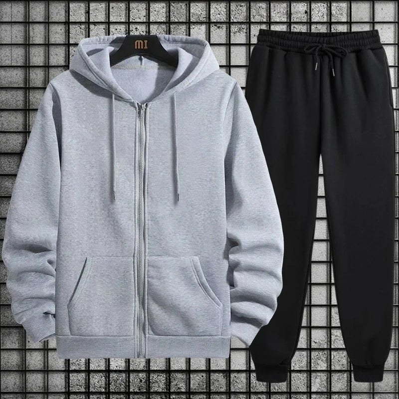 Gray hoodie with a zipper and black pants on a grid background