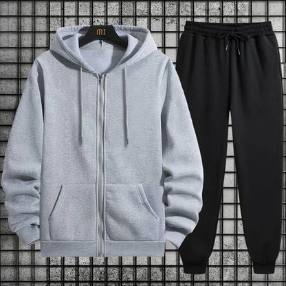 Gray hoodie with a zipper and black pants on a grid background
