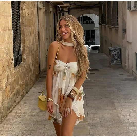 Woman in a white dress standing in a narrow alleyway