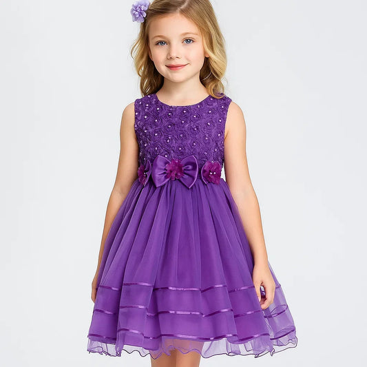 Young girl wearing a purple dress with a bow on a white background