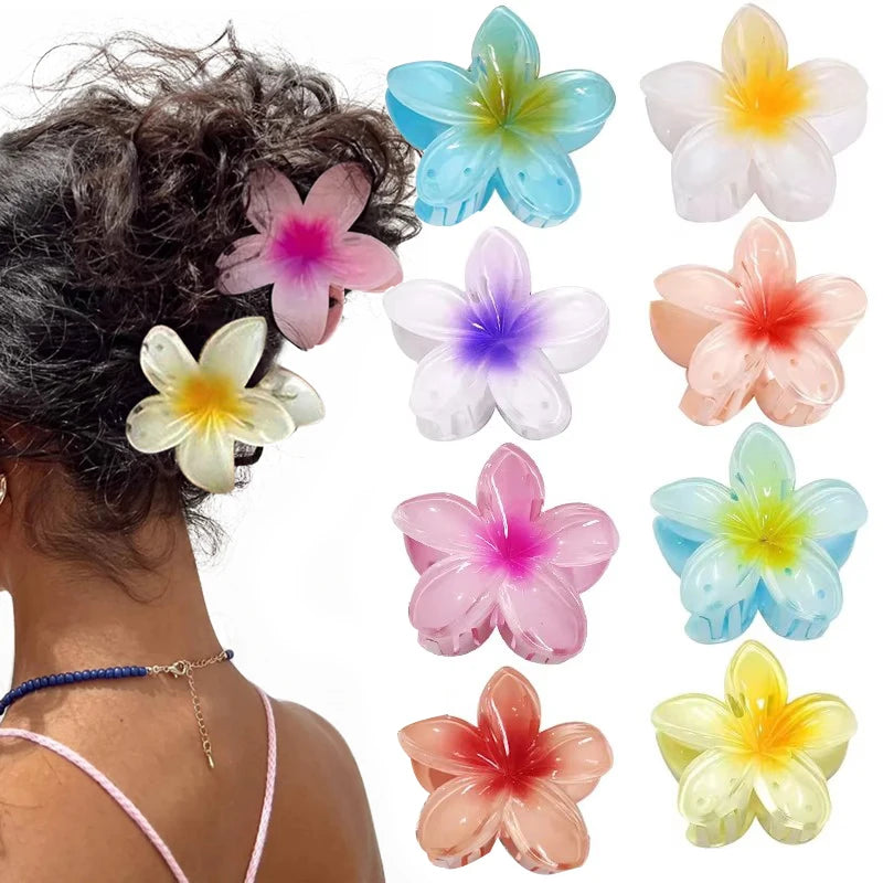 Colorful flower-shaped hair accessories on a person's head with additional flowers displayed.
