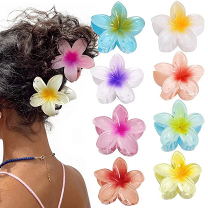 Colorful flower-shaped hair accessories on a person's head with additional flowers displayed.