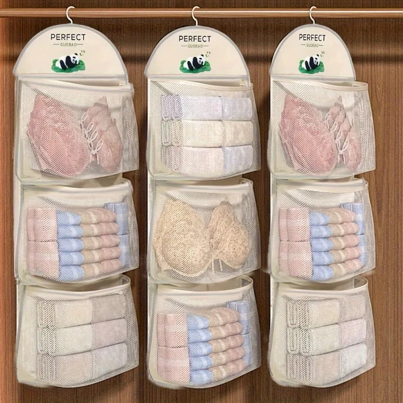 Three hanging mesh organizer pockets on a wooden closet door, each filled with folded towels, washcloths, and lace bra cups. Each pocket has a white header card printed with the brand name PERFECT and a small panda logo.