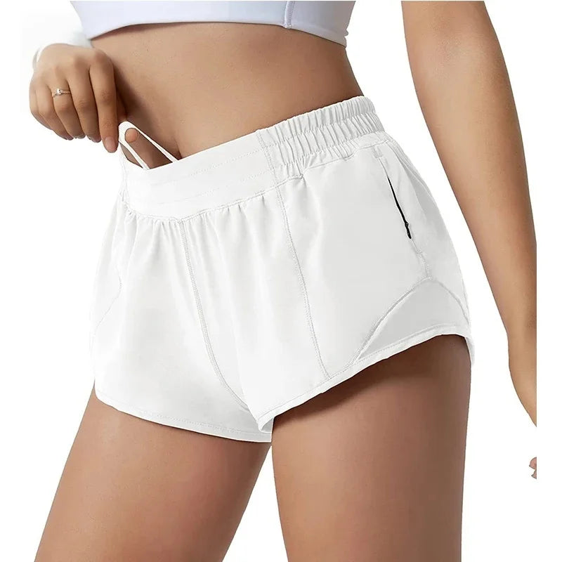 White athletic shorts worn by a person on a white background