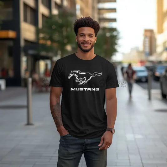 Man wearing a black t-shirt with Mustang logo on a city street