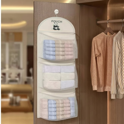 Hanging pouch organizer with towels on a wooden door, showing text 'Comes with hook design' and 'Hanging saves space'.