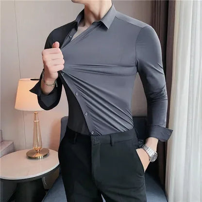 Person wearing a gray dress shirt and black pants in an indoor setting.