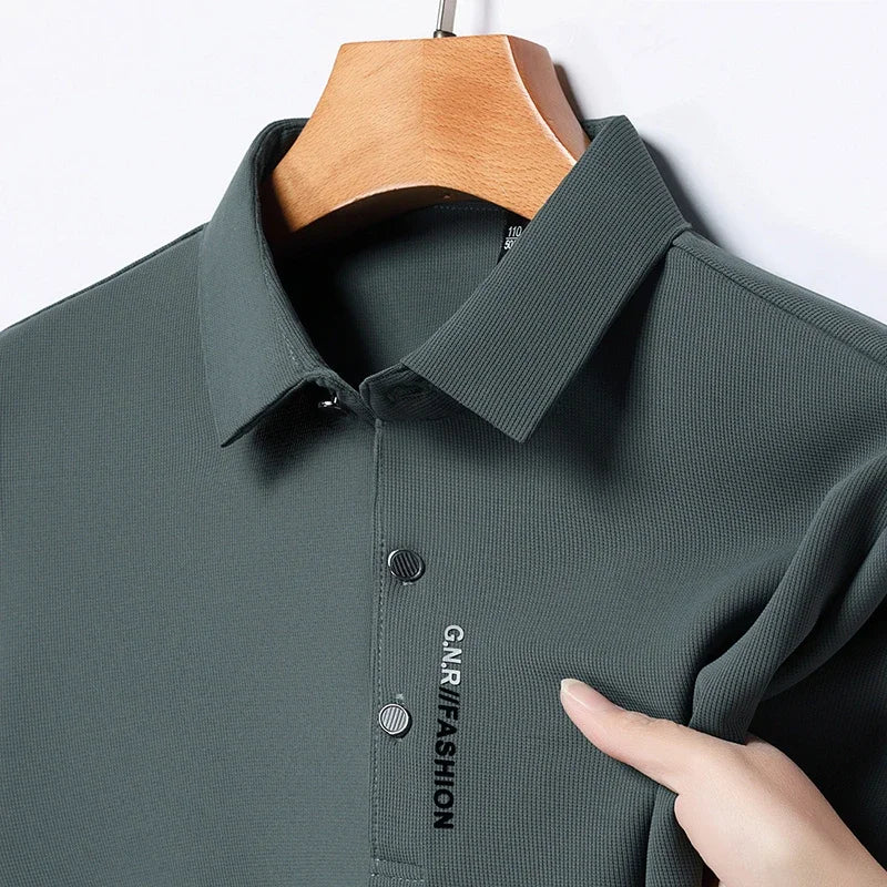 Green polo shirt on a hanger with 'GNR Fashion' branding.