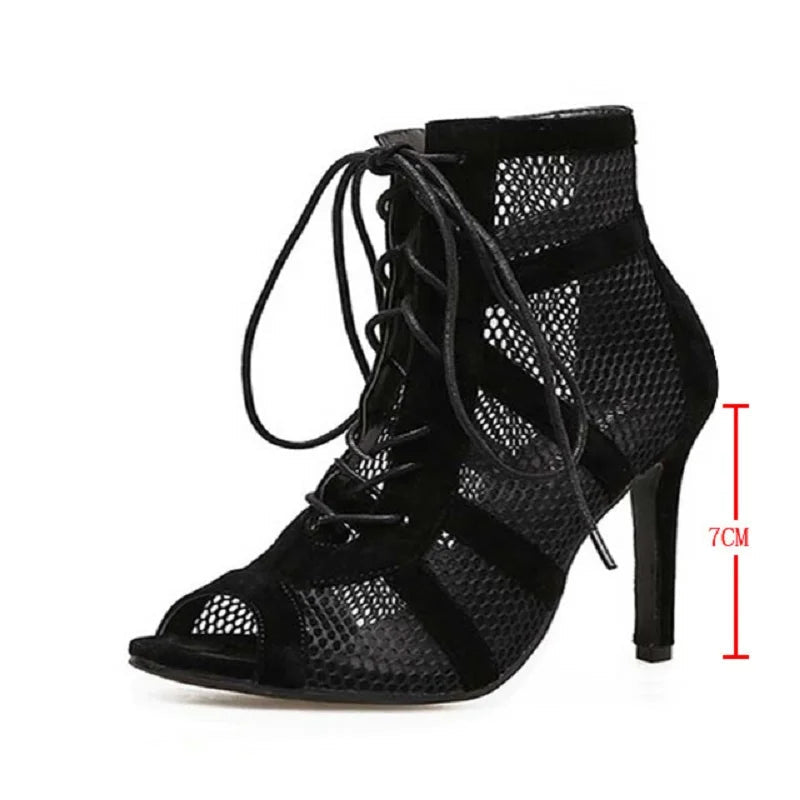 Black high-heeled shoe with open toe and lace-up design on a white background