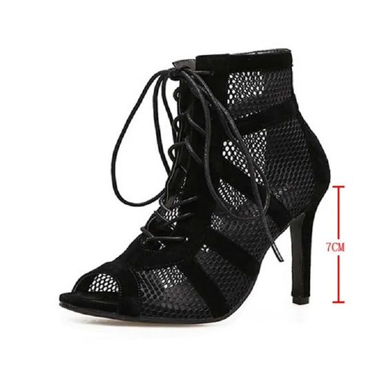 Black high-heeled shoe with open toe and lace-up design on a white background