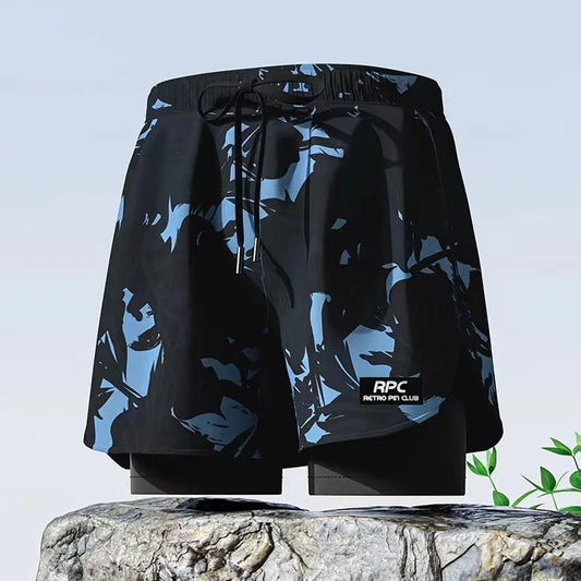 Black shorts with blue abstract pattern on a stone surface with a light blue background