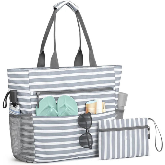 Striped tote bag with smaller pouch and beach items on a white background