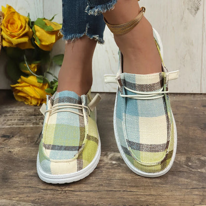 Plaid shoes on a wooden floor with yellow flowers in the background
