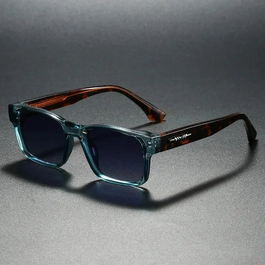 Sunglasses with tortoiseshell frame and blue lenses on a gray background