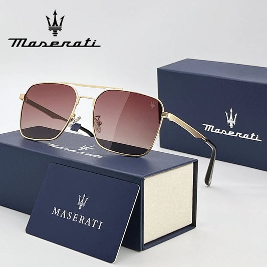 Maserati sunglasses with gold frame and brown lenses on a blue Maserati box.