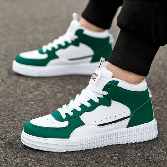 Green and white sneakers worn on a concrete surface