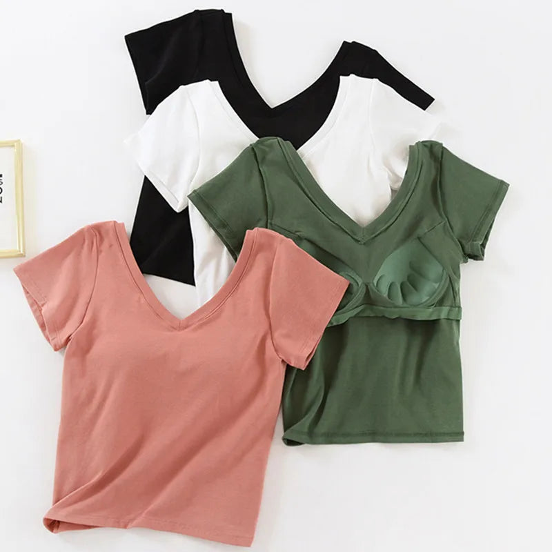 Three tank tops in black, pink, and green on a white background