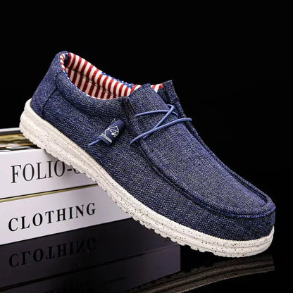 Blue casual shoe with white sole on a black background