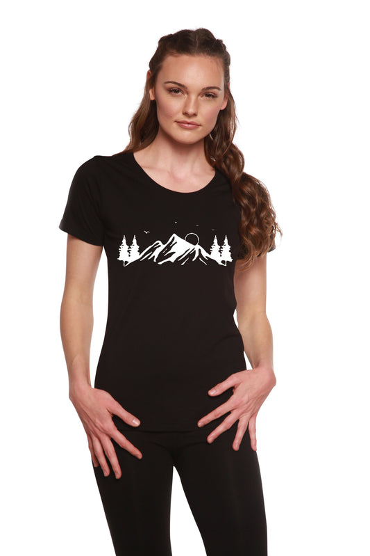 Woman wearing a black t-shirt with a mountain and tree design on a white background